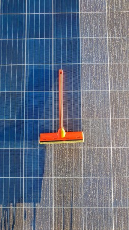 cleaning-dirty-solar-panel-sunset.jpg