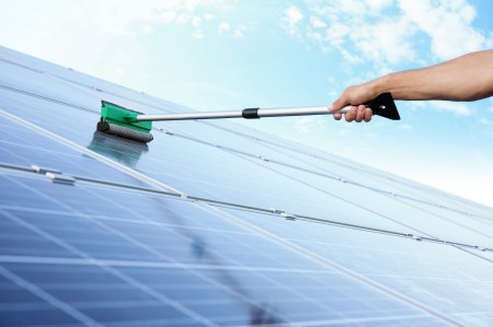 hand-worker-washing-solar-panels-after-installation-outdoors.jpg
